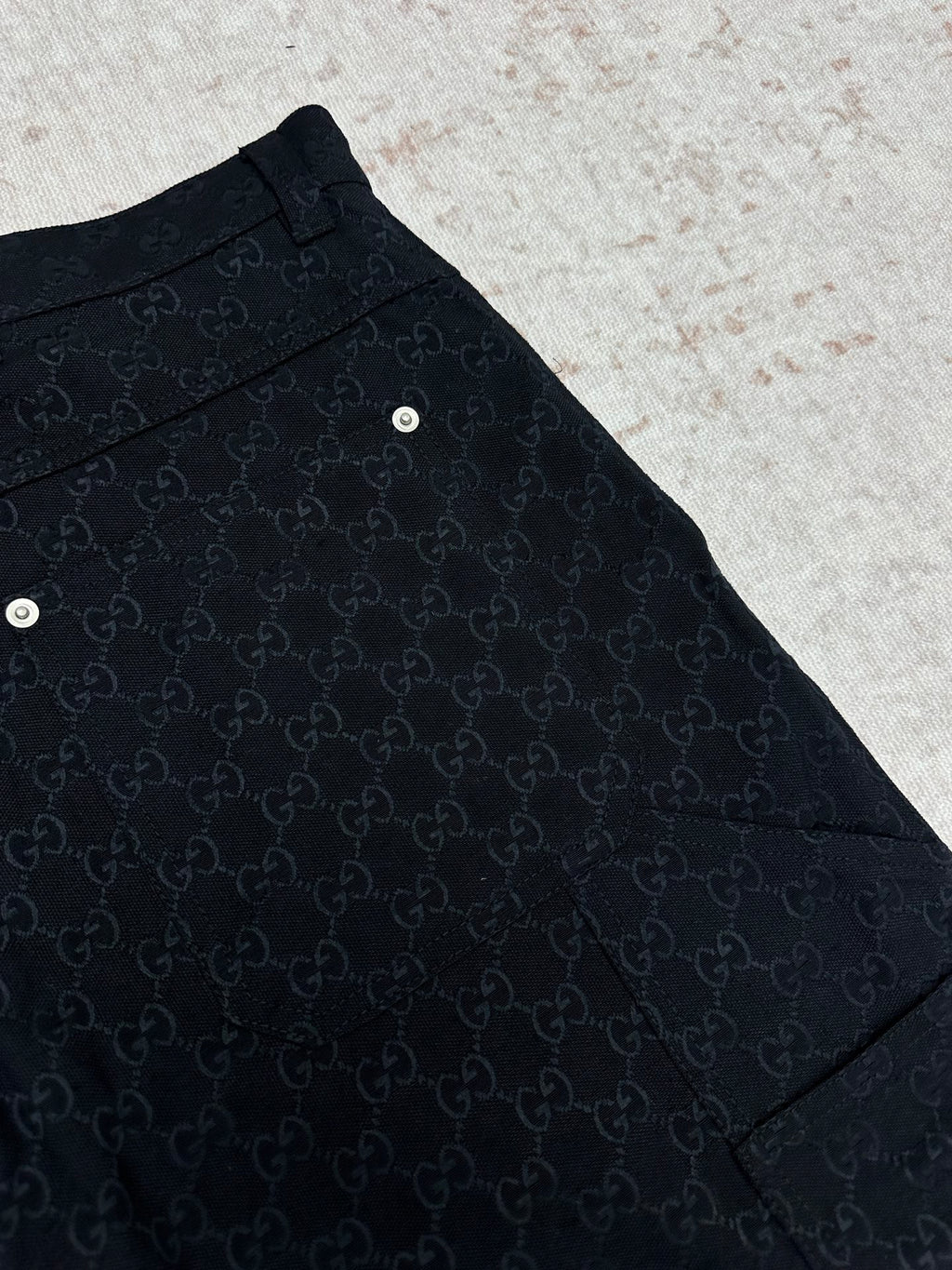 Gucci dark navy shorts with GG-style monogram pattern, curved side panel and hem