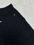 Gucci dark navy shorts with GG-style monogram pattern, curved side panel and hem
