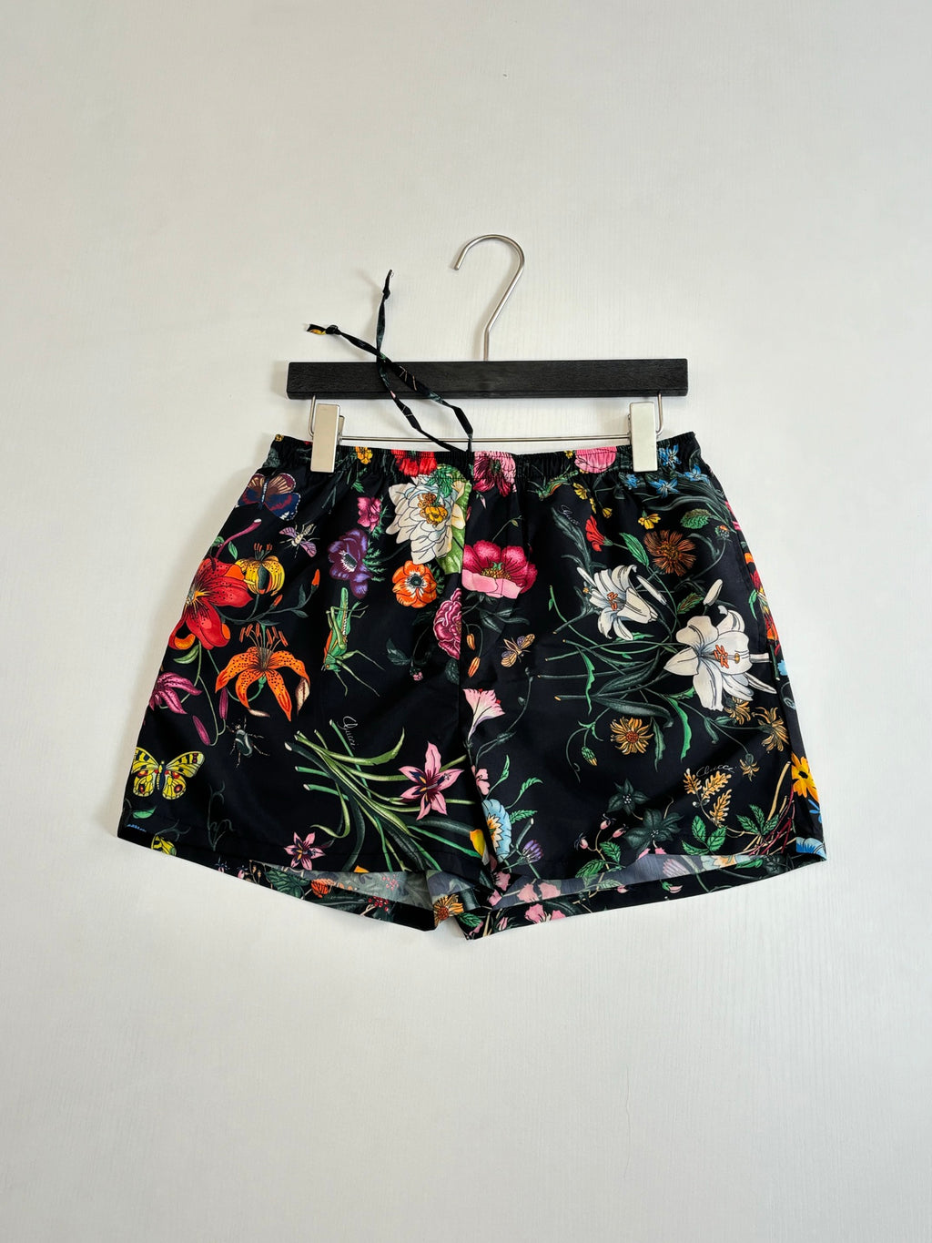 Gucci floral print shorts, black with vibrant blossoms and foliage pattern