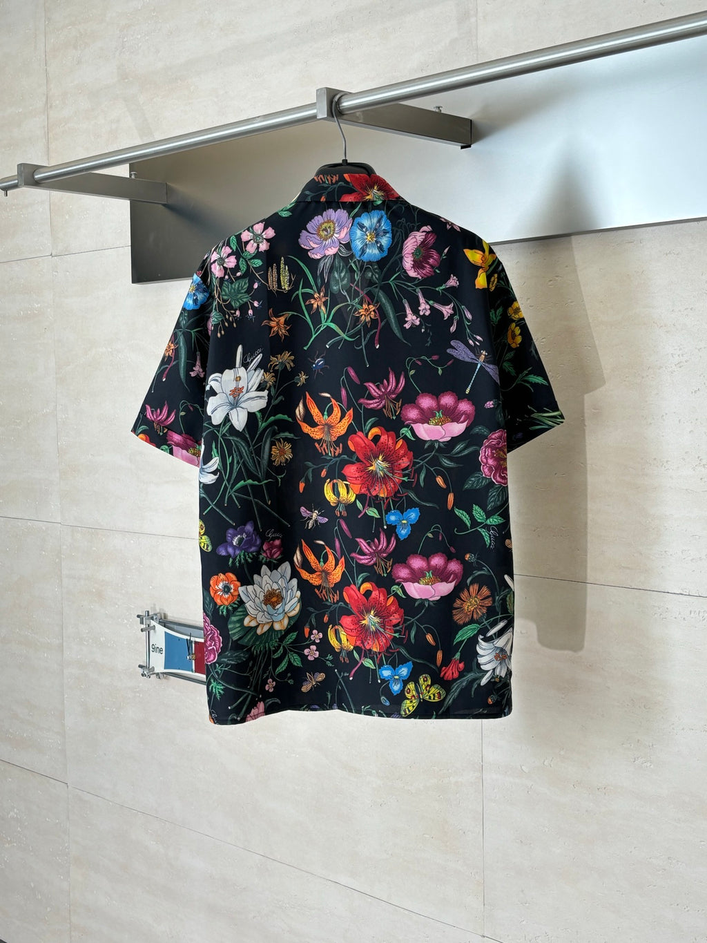 Black Gucci short-sleeve shirt, back view with colorful botanical and butterfly print