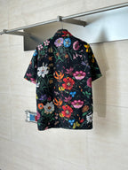 Black Gucci short-sleeve shirt, back view with colorful botanical and butterfly print