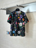 Black Gucci short-sleeve shirt with colorful floral and butterfly print, button-front