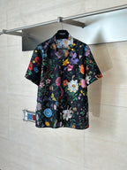 Black Gucci short-sleeve shirt with colorful floral and butterfly print, button-front