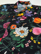 Black Gucci short-sleeve shirt with large floral and butterfly motifs, front close-up