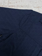 Dark navy short-sleeve shirt fabric with stitched seams and subtle GG pattern