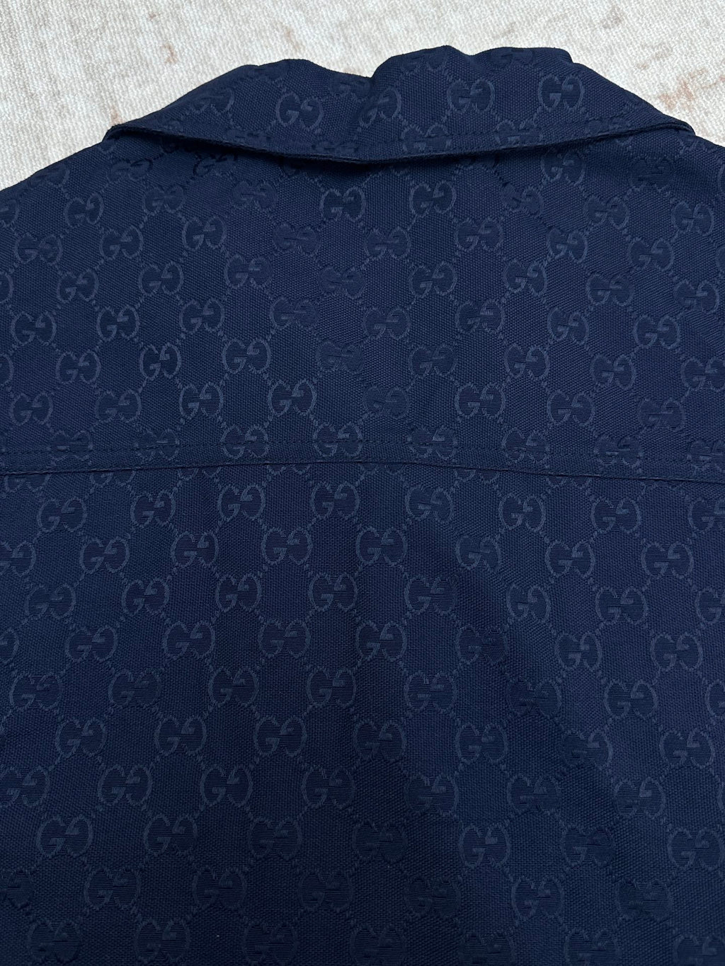 Dark navy short-sleeve button-up shirt back view with allover GG pattern