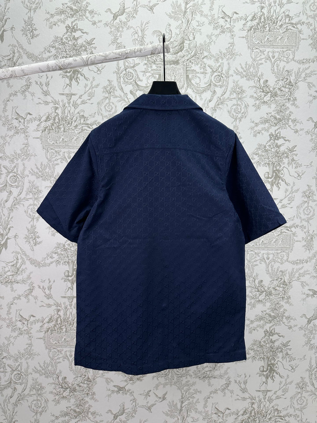 Dark navy short-sleeve button-up shirt, back view, with stand collar and straight hem