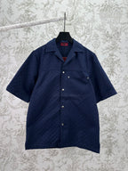 Dark navy short-sleeve button-up shirt with pointed collar and small front patch pockets