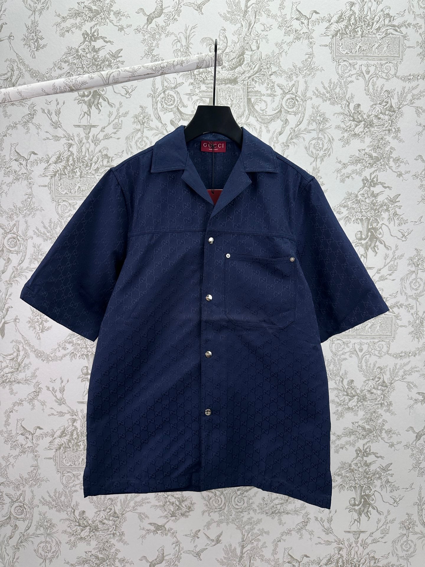 Dark navy short-sleeve button-up shirt with pointed collar and small front patch pockets