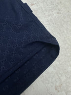 Gucci shorts in dark navy with monogram fabric, angled pocket, and seam