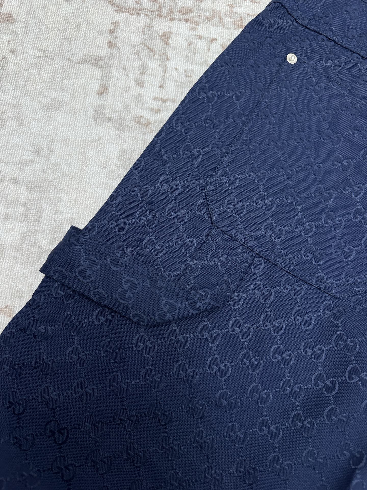 Gucci shorts in dark navy with monogram pattern, yoke seam, and side flap