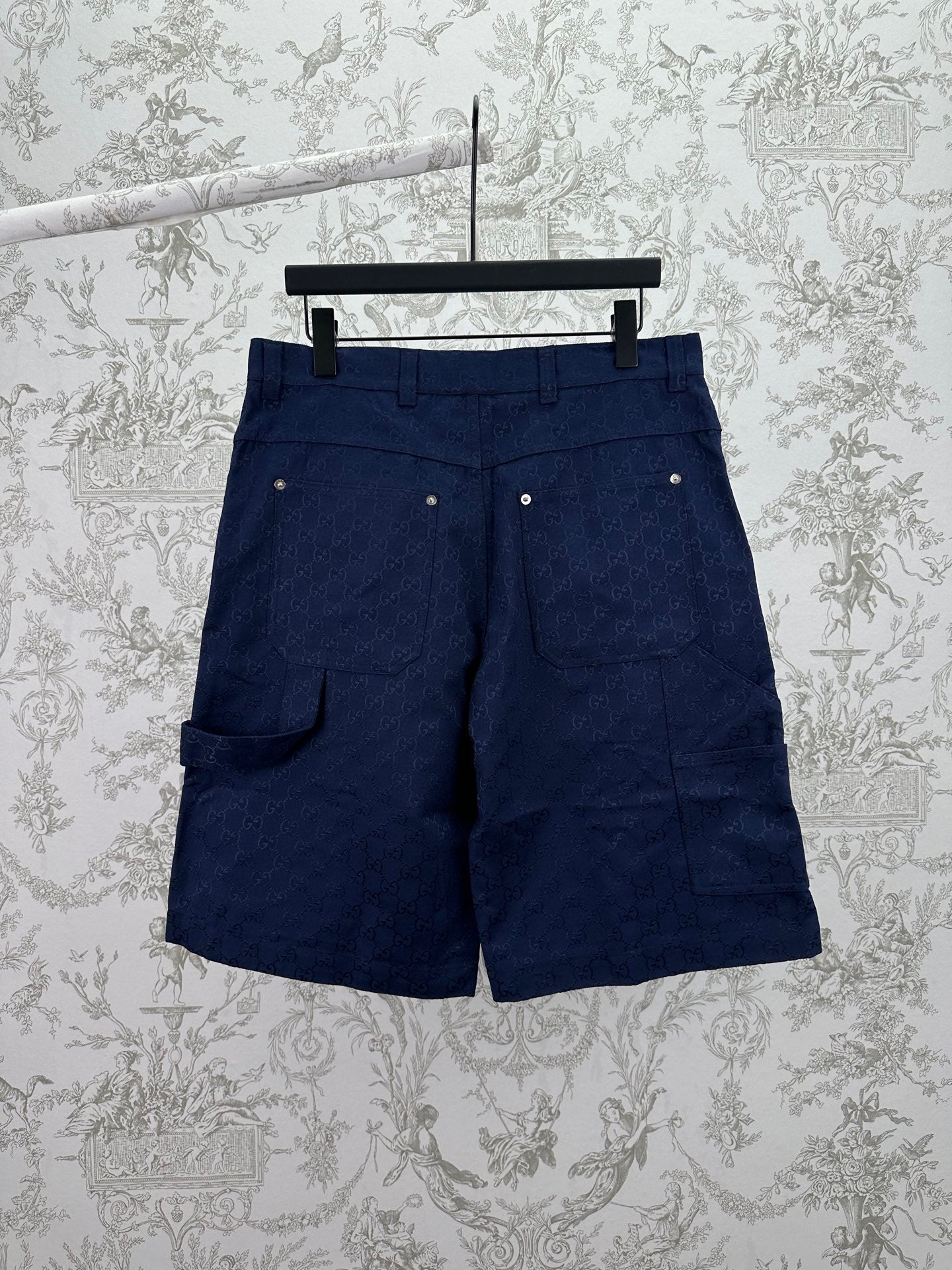 Gucci shorts in dark navy with flap pockets, button front, and belt loops