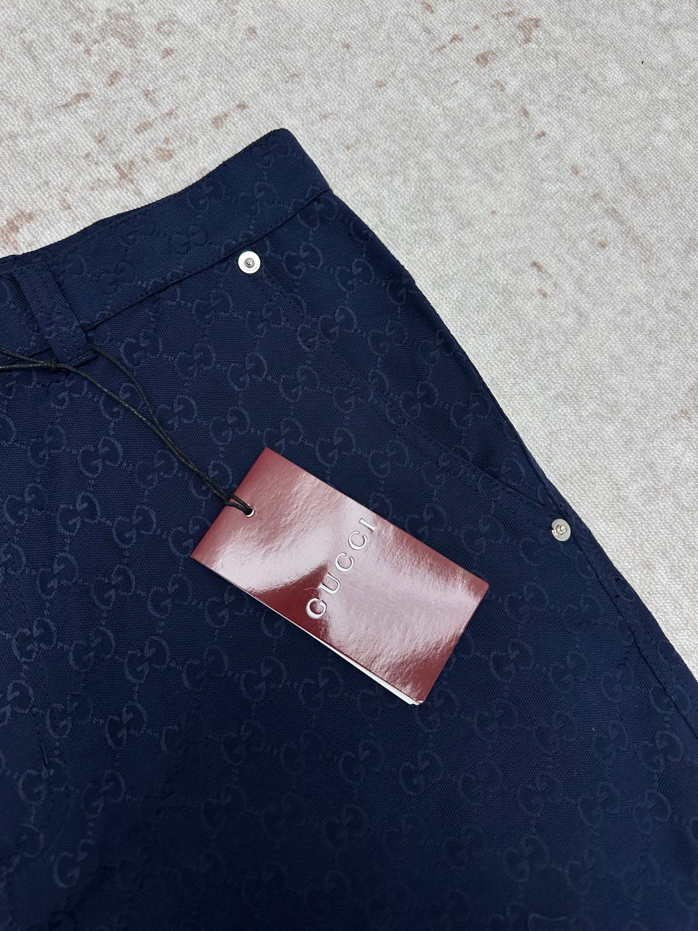 Gucci shorts in dark navy with monogram pattern and pocket tag detail