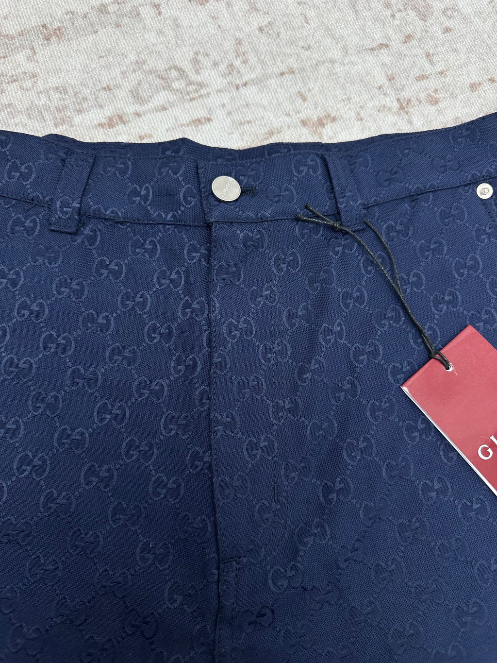 Gucci shorts in dark navy with monogram waistband, snap button, and cords