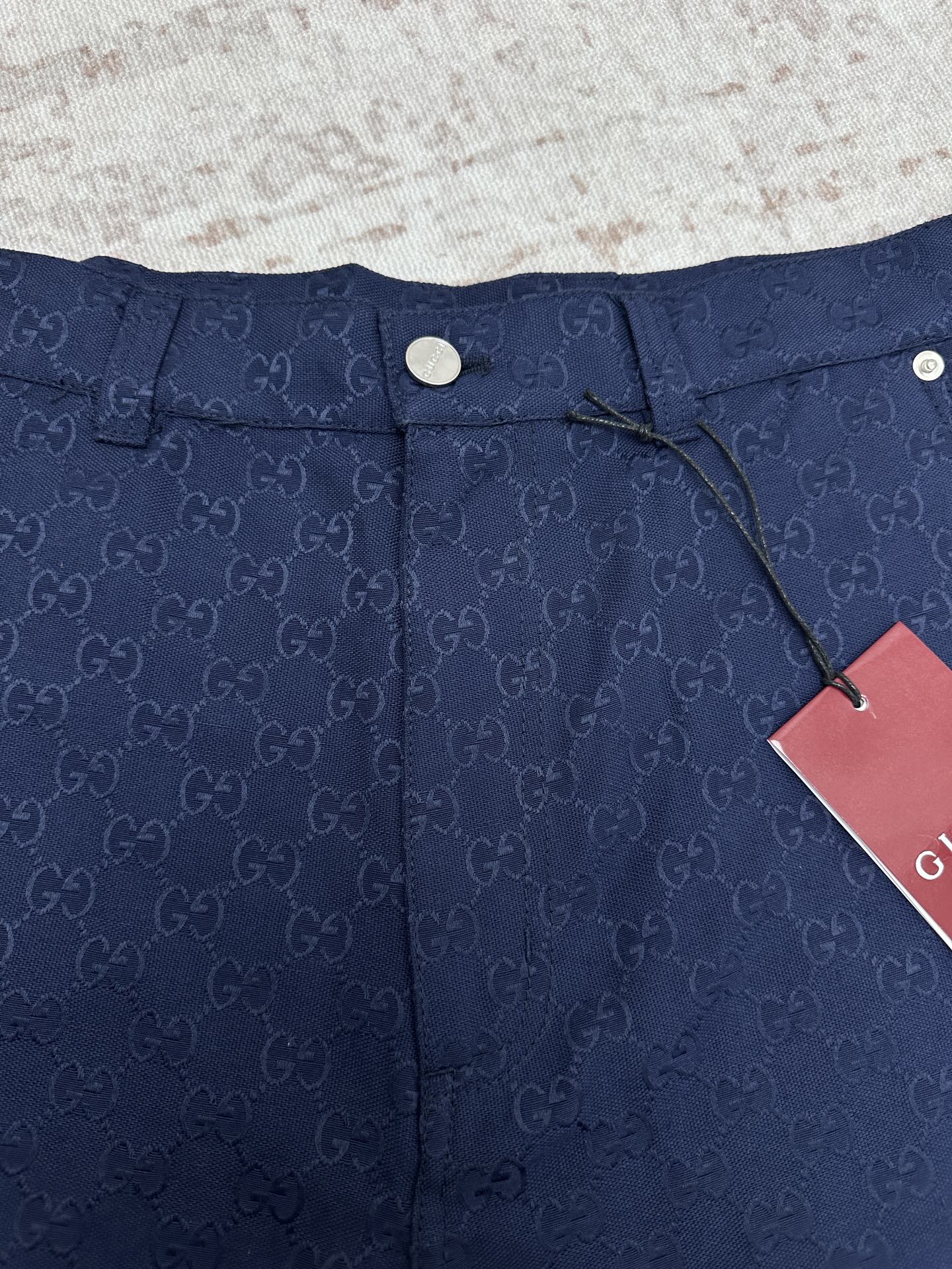 Gucci shorts in dark navy with monogram waistband, snap button, and cords