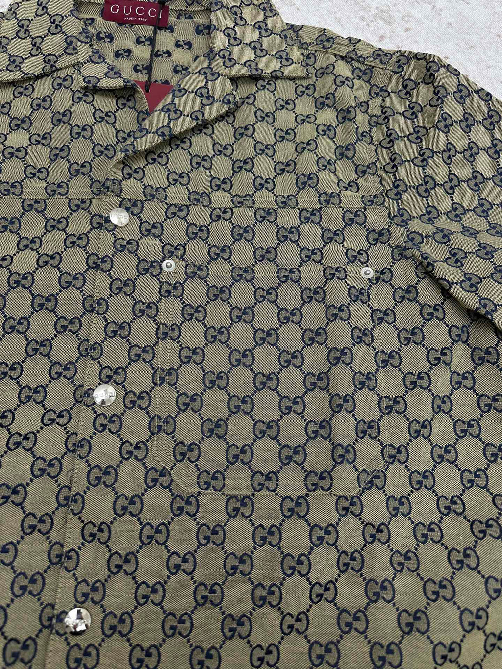 Gucci short-sleeve shirt front close-up with GG pattern and metal button details