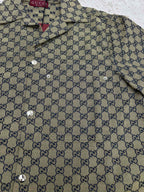 Gucci short-sleeve shirt front close-up with GG pattern and metal button details