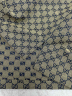 Gucci short-sleeve shirt fabric close-up with GG logo pattern and blue motif