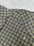 Gucci short-sleeve shirt fabric close-up with GG pattern and blue trim