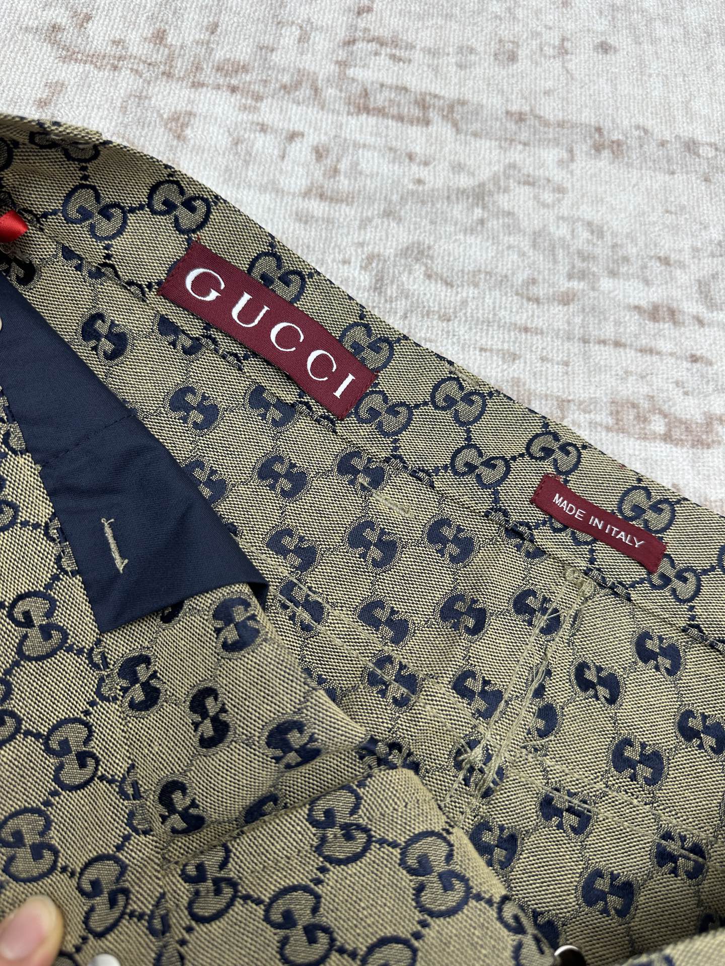 Gucci shorts inner waistband label with GG print and red brand tab
