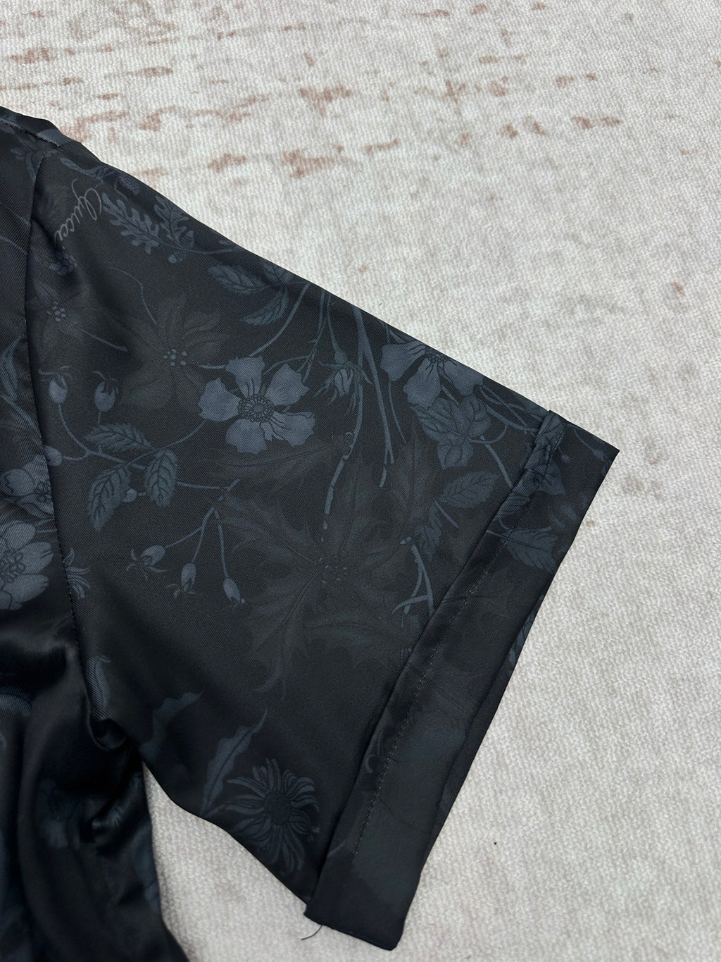 Short-sleeve shirt sleeve and shoulder, dark navy with subtle floral pattern