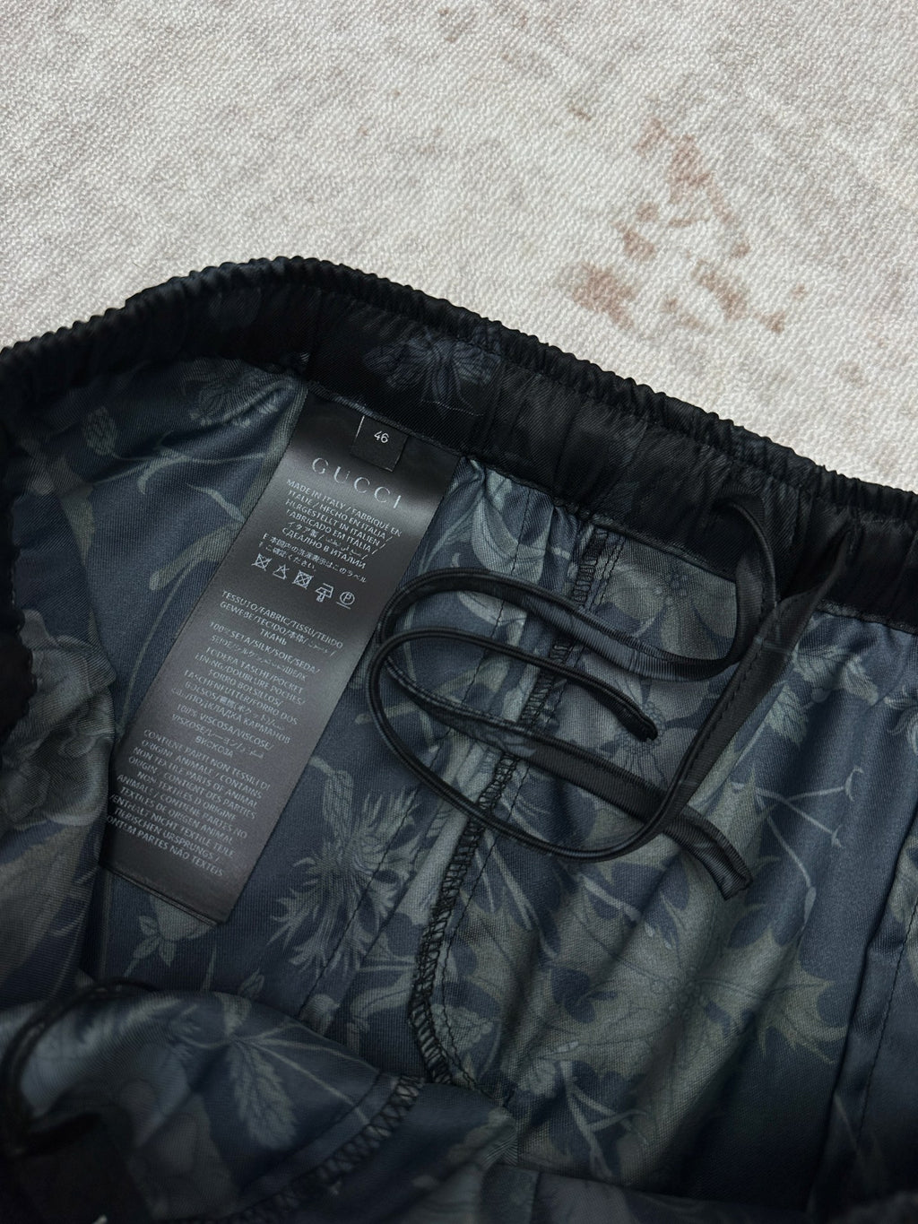 Dark floral shorts interior view showing care label and stitching