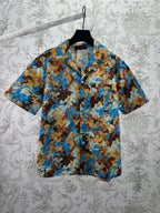 Short-sleeve button-up shirt with blue and tan bear print pattern
