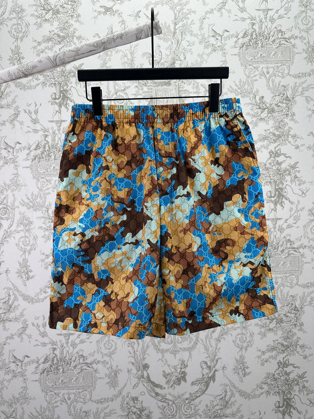 Gucci shorts in blue, brown, and tan camouflage-style print with elastic waistband