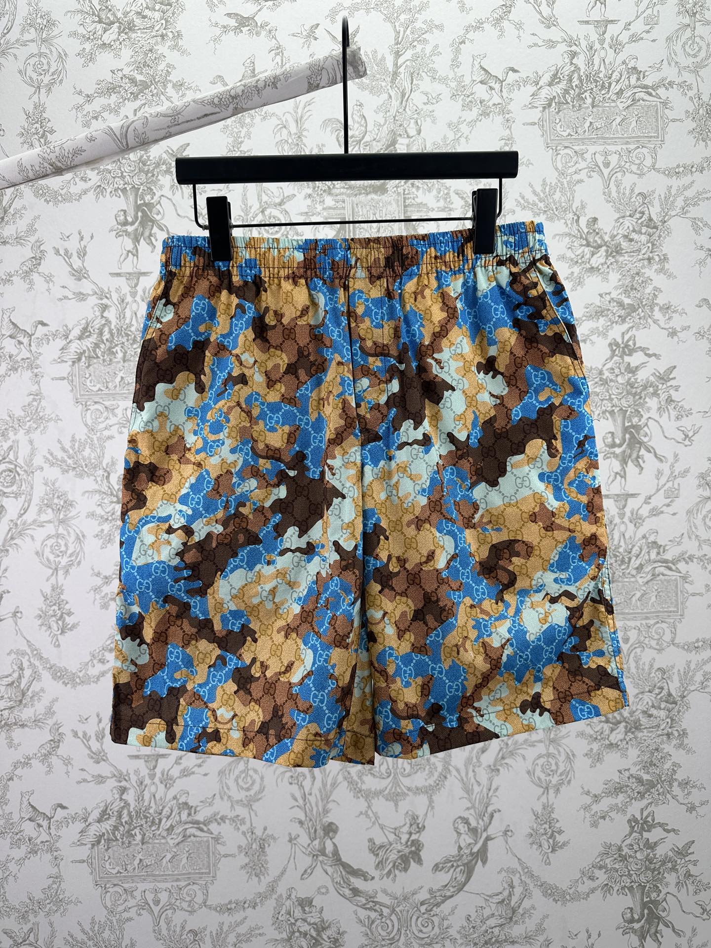 Gucci shorts in blue, brown, and tan camouflage-style print with elastic waistband