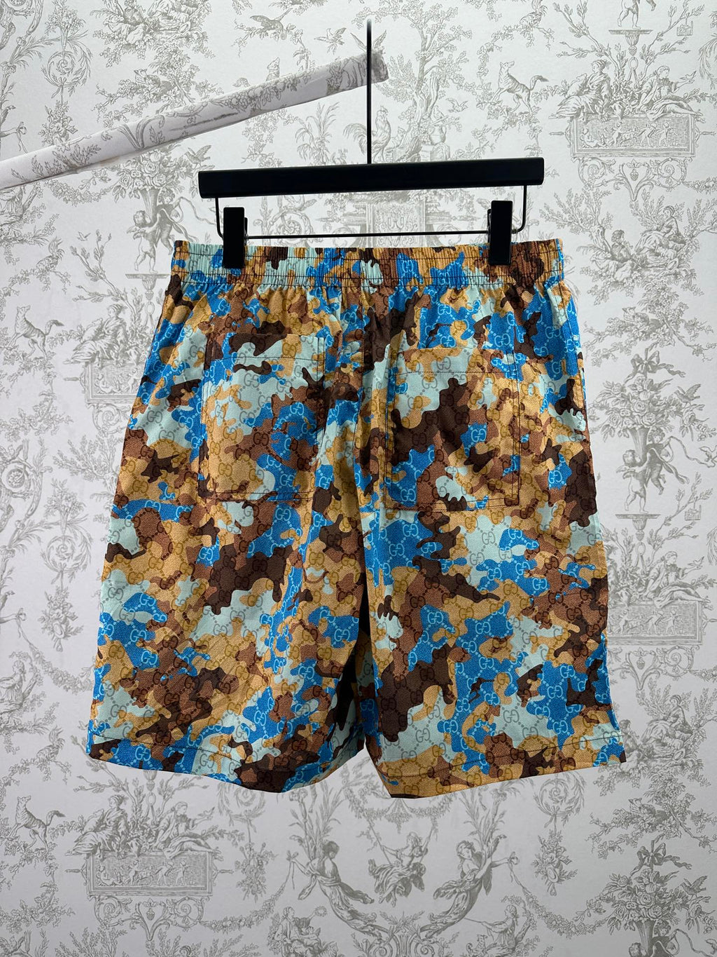 Gucci shorts on hanger with blue and brown patterned fabric and elastic waistband
