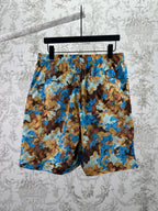 Gucci shorts on hanger with blue and brown patterned fabric and elastic waistband
