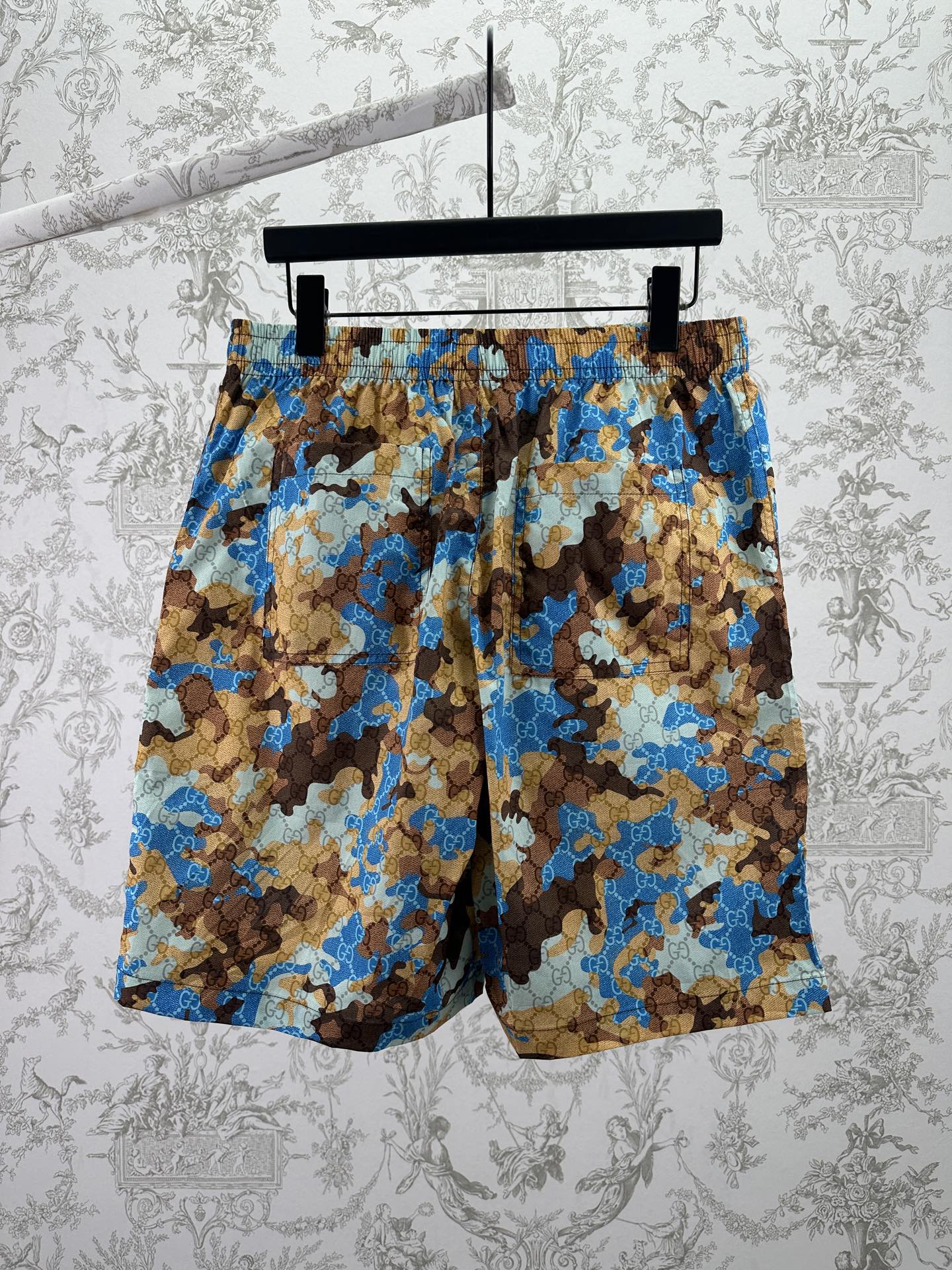 Gucci shorts on hanger with blue and brown patterned fabric and elastic waistband