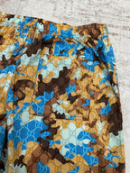 Gucci shorts waistband and side panel with blue, tan, and brown allover print