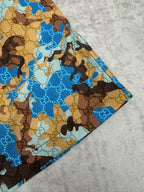 Gucci shorts side view with blue and brown patterned fabric and stitched hem