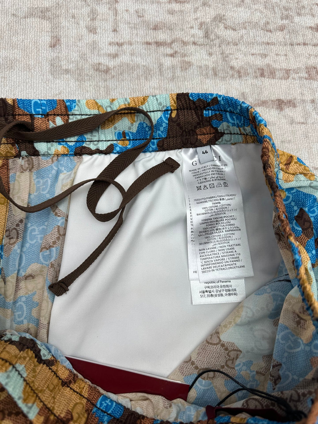 Gucci shorts interior view with white care label and black drawstrings