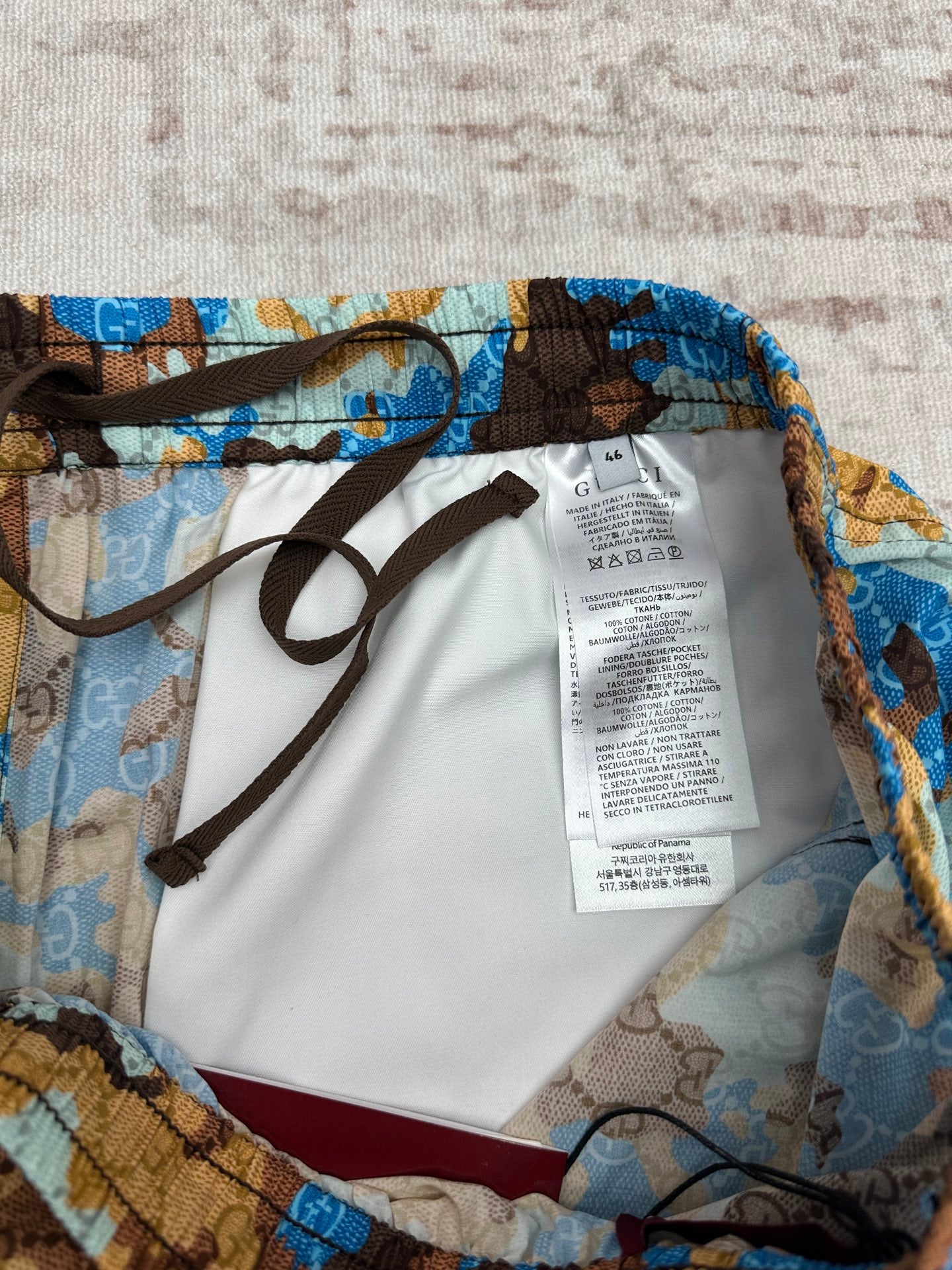Gucci shorts interior view with white care label and black drawstrings
