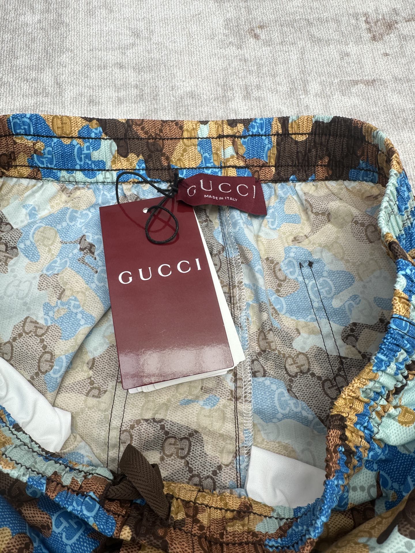 Gucci shorts waistband with Gucci tag and red interior paper label