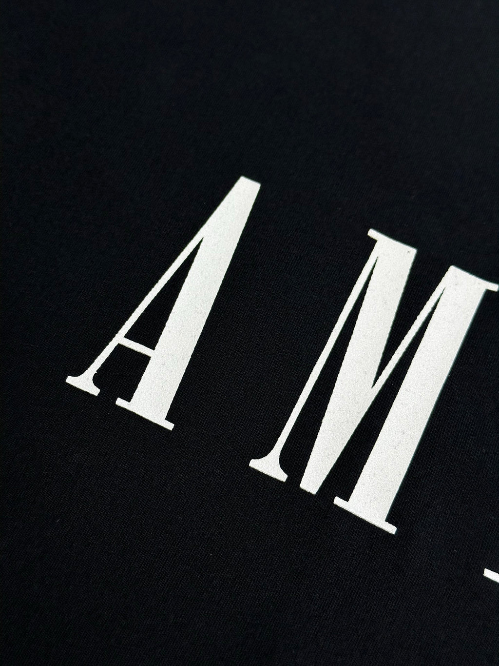 Black Amiri T-shirt with AMIRI logo in white letters