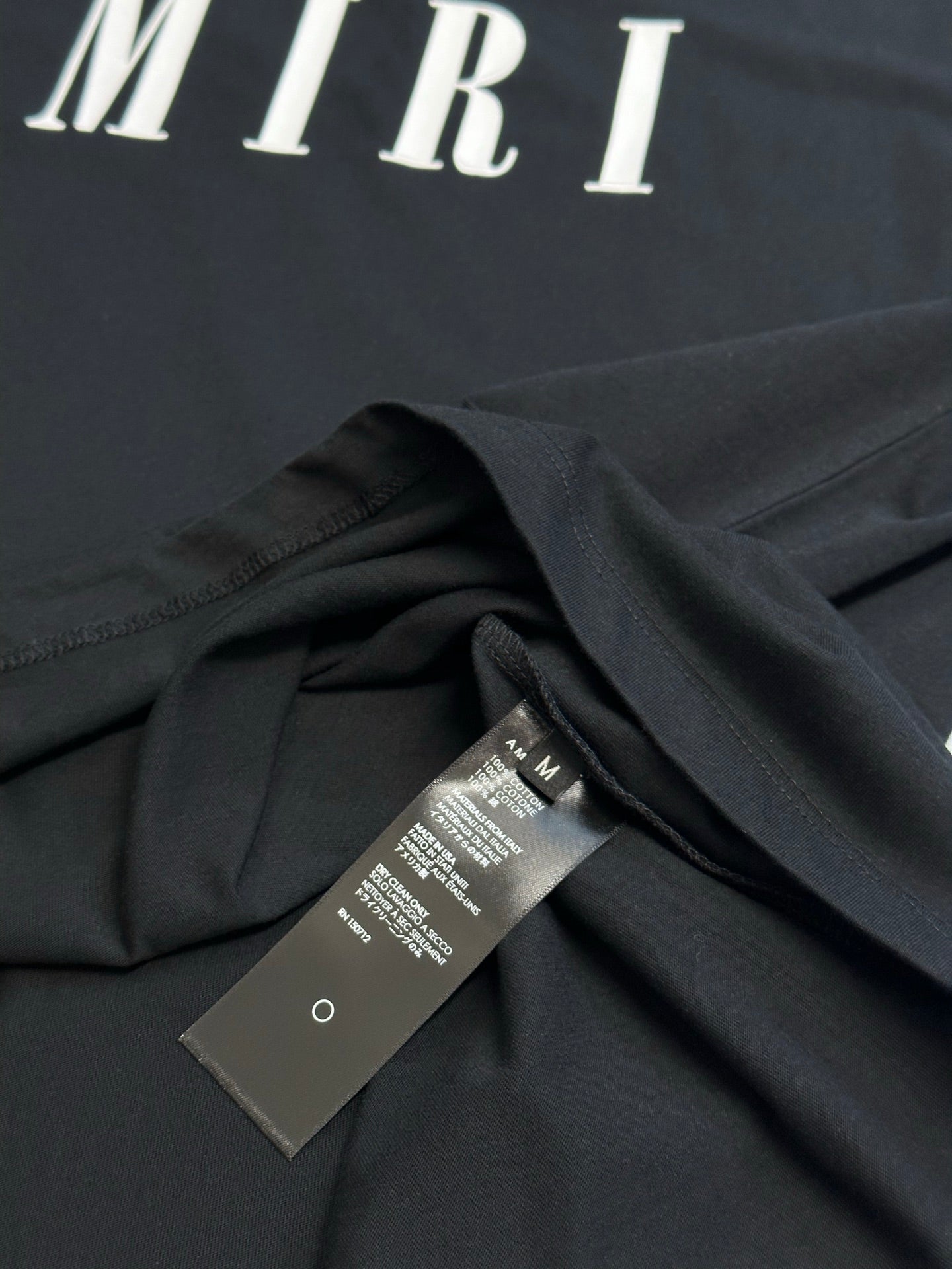 Black Amiri T-shirt draped with inner care label