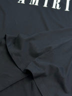 Black Amiri T-shirt fabric close-up with stitched seam