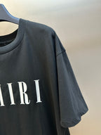 Black Amiri T-shirt sleeve with partial AMIRI lettering print