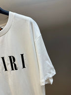 White T-shirt sleeve with partial AMIRI logo print