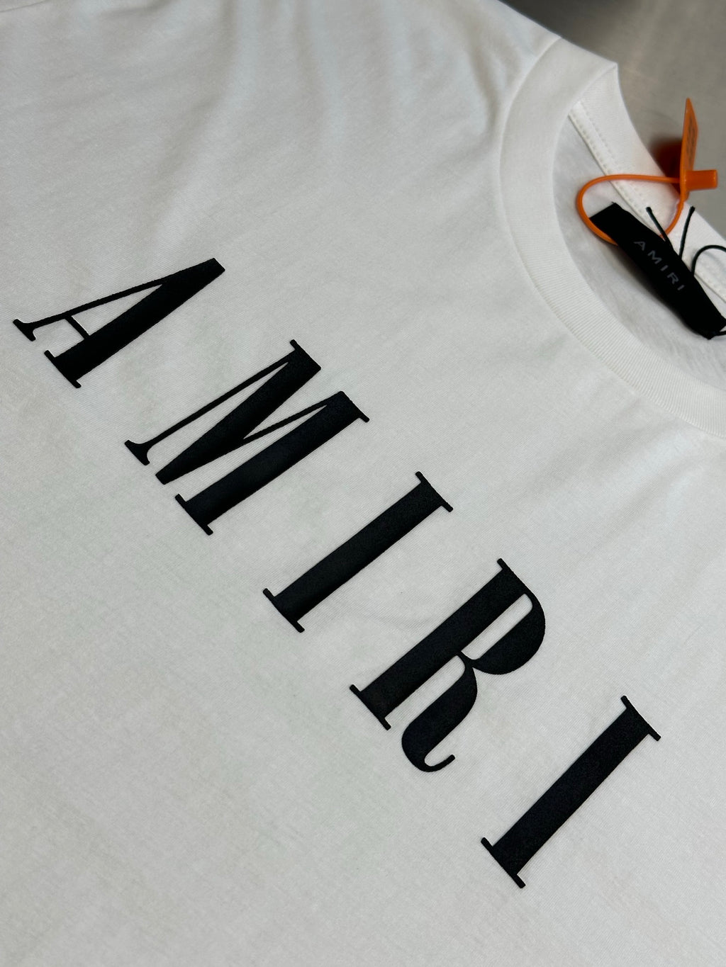 White T-shirt with AMIRI logo lettering close-up