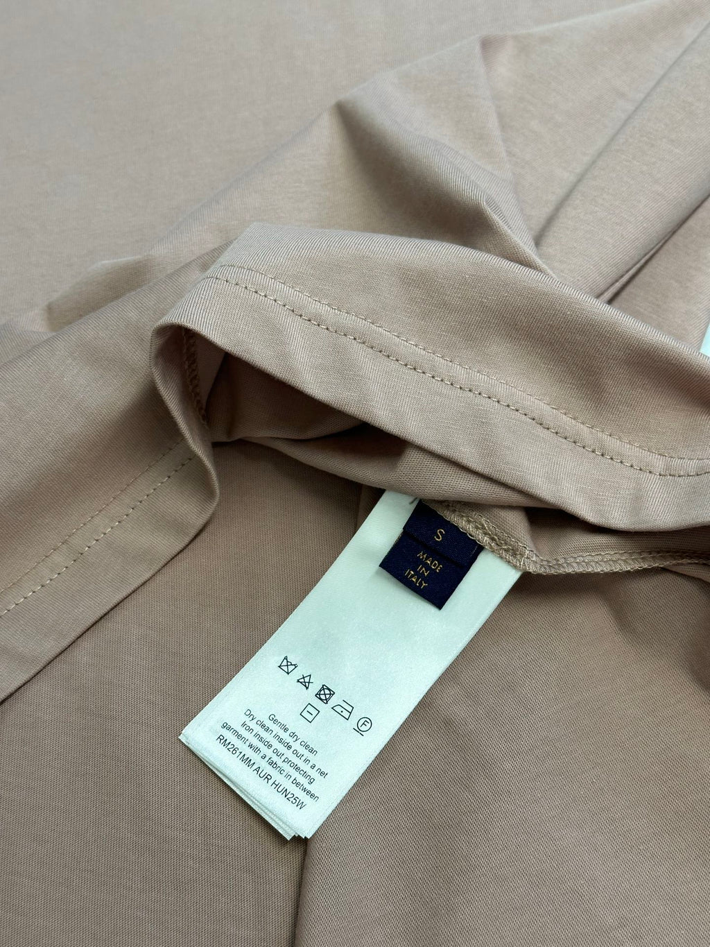Light pink T-shirt with care label on the inner seam