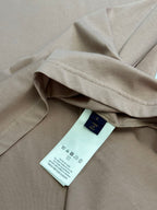 Light pink T-shirt with care label on the inner seam