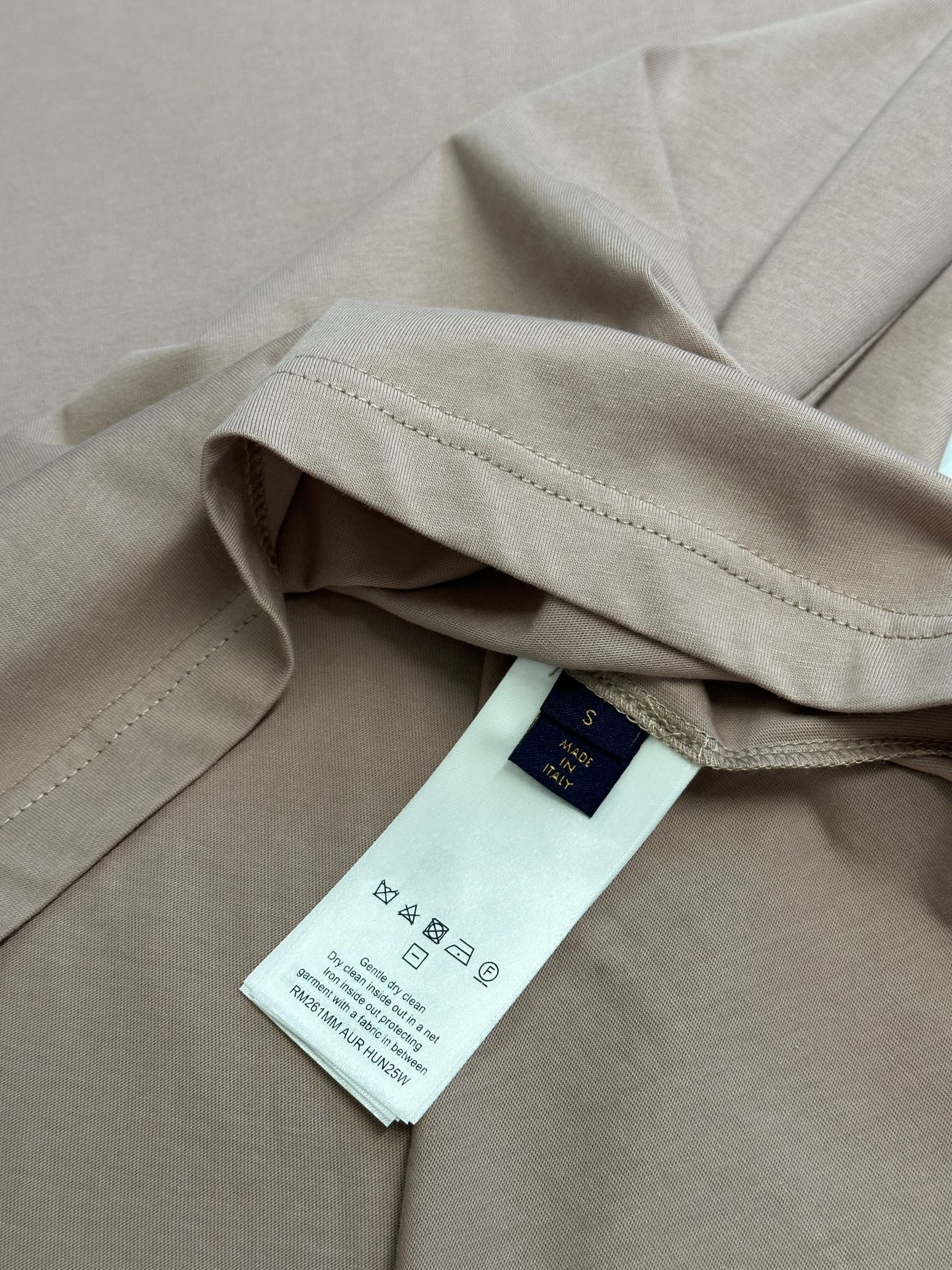 Light pink T-shirt with care label on the inner seam