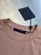 Light pink crewneck T-shirt with navy inner neck label and swing tag