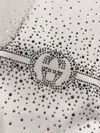 Gucci white T-shirt detail: dense rhinestone speckle fabric with centered logo