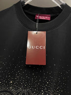 Black Gucci short-sleeve T-shirt with Gucci hang tag and rhinestone emblem