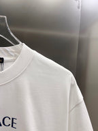White T-shirt side view with crewneck and part of blue logo print